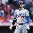 A baseball player wearing a Los Angeles Dodgers uniform, standing on the field during a game. A baseball player wearing a Los Angeles Dodgers uniform, standing on the field during a game.