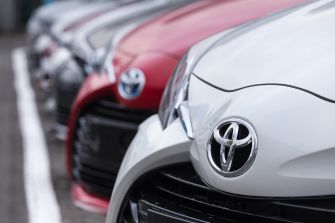 A close-up of the front of several Toyota vehicles, highlighting the iconic Toyota emblem.