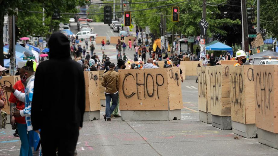 Cement and wood barricades bear the name CHOP June 16, 2020, inside what has been named the Capitol Hill Occupied Protest zone in Seattle.  (AP Photo/Ted S. Warren / AP Newsroom via Fox Business)