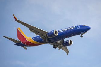 Southwest Airlines aircraft in flight against a blue sky.
