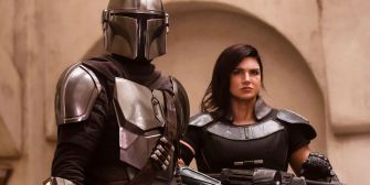 Gina Carano and a character in armor from 'The Mandalorian' standing together in a scene from the series.