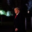 Former President Trump walking outside at night. Former President Trump walking outside at night.