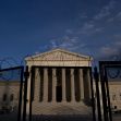 The exterior of the U.S. Supreme Court building, partially fenced with barbed wire. The exterior of the U.S. Supreme Court building, partially fenced with barbed wire.
