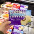 Smucker's Uncrustables peanut butter and grape jelly sandwich packaging displayed in a grocery store. Smucker's Uncrustables peanut butter and grape jelly sandwich packaging displayed in a grocery store.