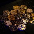 A collection of various cryptocurrency coins arranged on a laptop keyboard. A collection of various cryptocurrency coins arranged on a laptop keyboard.