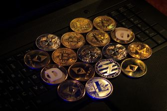 A collection of various cryptocurrency coins arranged on a laptop keyboard.