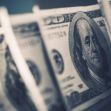 Close-up of American hundred dollar bills with a focus on Benjamin Franklin's portrait. Close-up of American hundred dollar bills with a focus on Benjamin Franklin's portrait.