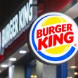 Signage of a Burger King restaurant at night. Signage of a Burger King restaurant at night.