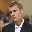 Justin Bieber at an event, looking serious in a formal outfit. Justin Bieber at an event, looking serious in a formal outfit.