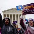 Demonstrators holding signs that say "People Over Politics" outside the U.S. Supreme Court building. Demonstrators holding signs that say "People Over Politics" outside the U.S. Supreme Court building.