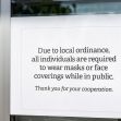 Sign informing the public about local ordinance requiring masks or face coverings in public. Sign informing the public about local ordinance requiring masks or face coverings in public.