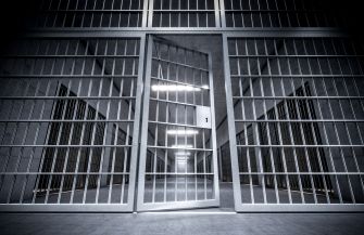 Image of open prison cell doors, symbolizing issues related to correctional facilities and legal rights.