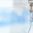 IV bag in a medical setting against a blurred background. IV bag in a medical setting against a blurred background.