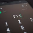 Image of a smartphone screen displaying the emergency number 911 on the dialing interface. Image of a smartphone screen displaying the emergency number 911 on the dialing interface.