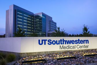 Exterior view of the UT Southwestern Medical Center, featuring the facility's signage and landscaped surroundings.
