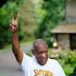 Bill Cosby raising his hand in a victory gesture while surrounded by supporters after his release from prison. Bill Cosby raising his hand in a victory gesture while surrounded by supporters after his release from prison.