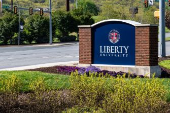 Signage for Liberty University located at the campus entrance.