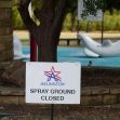 Sign indicating that the spray ground is closed, located in Arlington, Texas. Sign indicating that the spray ground is closed, located in Arlington, Texas.