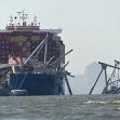 A cargo ship damaging a bridge after a collision in Baltimore, with emergency responders at the scene. A cargo ship damaging a bridge after a collision in Baltimore, with emergency responders at the scene.