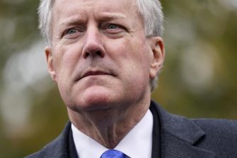 Mark Meadows, former White House chief of staff, captured in a pensive expression outdoors.