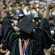 A jubilant graduate celebrating at a commencement ceremony, surrounded by the cheering crowd. A jubilant graduate celebrating at a commencement ceremony, surrounded by the cheering crowd.