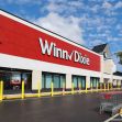 Exterior view of a Winn-Dixie supermarket building with shopping carts outside. Exterior view of a Winn-Dixie supermarket building with shopping carts outside.