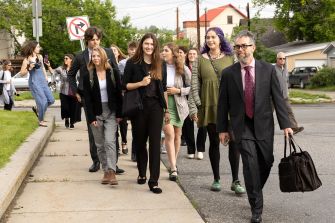 A group of young plaintiffs and their attorney walking together, advocating for climate rights in Montana.