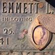 Memorial plaque for Emmett L. Till, featuring his name, date of birth, and an image surrounded by coins. Memorial plaque for Emmett L. Till, featuring his name, date of birth, and an image surrounded by coins.
