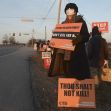 A protester holding signs against the death penalty outside a federal prison during the execution of Lisa Montgomery. A protester holding signs against the death penalty outside a federal prison during the execution of Lisa Montgomery.