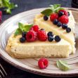 A slice of cheesecake topped with fresh raspberries and blueberries on a plate, symbolizing the poisoned dessert involved in a murder attempt case. A slice of cheesecake topped with fresh raspberries and blueberries on a plate, symbolizing the poisoned dessert involved in a murder attempt case.