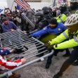 Rioters try to break through a police barrier at the Capitol in Washington. (AP Photo/John Minchillo, File)