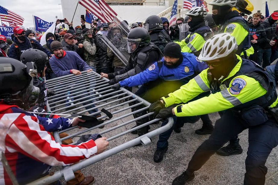 Rioters try to break through a police barrier at the Capitol in Washington. (AP Photo/John Minchillo, File)