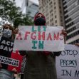A group of protesters holding signs advocating for Afghan nationals to be allowed entry into the United States, emphasizing the urgency of the situation. A group of protesters holding signs advocating for Afghan nationals to be allowed entry into the United States, emphasizing the urgency of the situation.