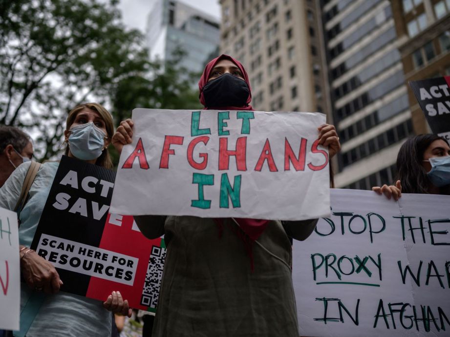 Members and supporters of New York’s Afghan community hold placards at a march aiming to raise awareness of Afghanistan’s refugee crisis,