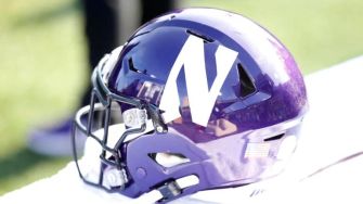 A Northwestern University football helmet with a prominent "N" logo.