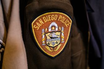 San Diego Police Department emblem on an officer's uniform.
