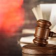 A wooden gavel on a sound block with open books in the background, symbolizing a legal decision or court ruling. A wooden gavel on a sound block with open books in the background, symbolizing a legal decision or court ruling.