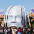 A large sculpture of a head with the text "ASTRO WORLD" displayed above, surrounded by attendees at the Astroworld music festival. A large sculpture of a head with the text "ASTRO WORLD" displayed above, surrounded by attendees at the Astroworld music festival.