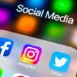 Social media apps displayed on a smartphone screen with a blurred background. Social media apps displayed on a smartphone screen with a blurred background.