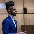 Rapper YNW Melly standing in a courtroom during his trial proceedings. Rapper YNW Melly standing in a courtroom during his trial proceedings.