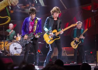 The Rolling Stones performing on stage during a concert.