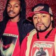 Two men posing together, both wearing red clothing and looking towards the camera. Two men posing together, both wearing red clothing and looking towards the camera.
