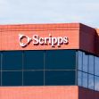 Building exterior with the Scripps logo against a blue sky. Building exterior with the Scripps logo against a blue sky.