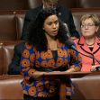 US Rep. Ayanna Pressley speaking at a podium in the House of Representatives, with Senator Tammy Duckworth seated behind her. US Rep. Ayanna Pressley speaking at a podium in the House of Representatives, with Senator Tammy Duckworth seated behind her.