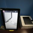 Voting machine and printer setup showing a touchscreen interface with instructional graphics. Voting machine and printer setup showing a touchscreen interface with instructional graphics.