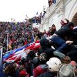 A large crowd of protesters outside the U.S. Capitol building during the January 6 event, with individuals climbing the barriers and waving flags. A large crowd of protesters outside the U.S. Capitol building during the January 6 event, with individuals climbing the barriers and waving flags.
