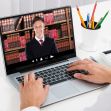 A person using a laptop to video conference with an attorney, surrounded by office supplies and books in the background. A person using a laptop to video conference with an attorney, surrounded by office supplies and books in the background.