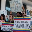 Venezuelan advocates holding signs during a protest calling to restore temporary protected status (TPS) for Venezuelans. Venezuelan advocates holding signs during a protest calling to restore temporary protected status (TPS) for Venezuelans.