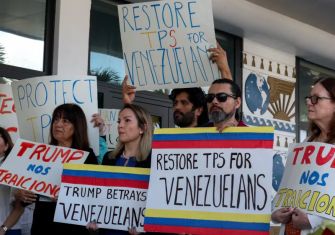 Venezuelan advocates holding signs during a protest calling to restore temporary protected status (TPS) for Venezuelans.