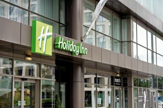 Holiday Inn signage at the entrance of a hotel building.